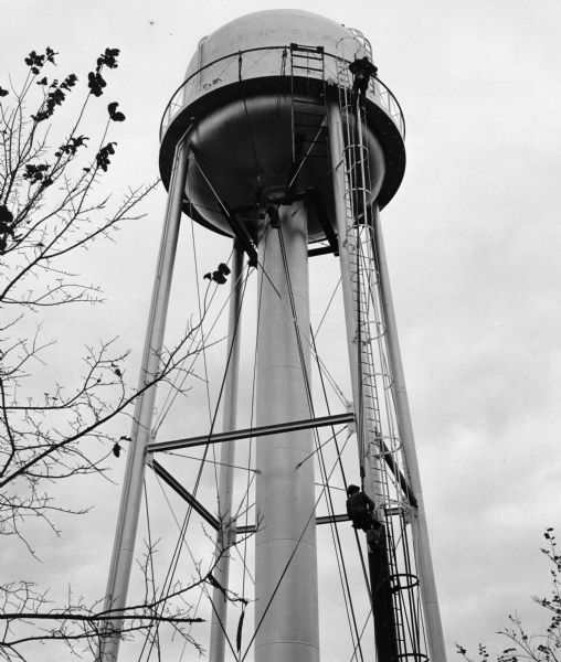 "Workers put the finishing touches on the new water tower."