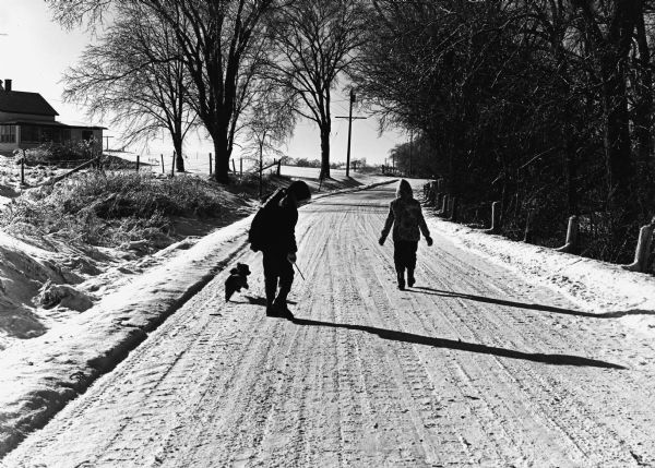 "Brenda & Kay Widmer walk on McArthur Road."