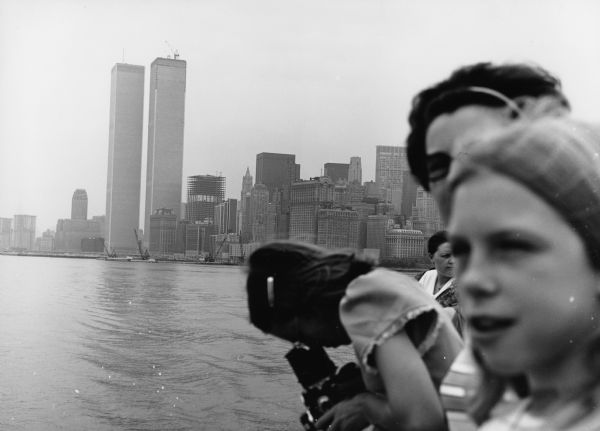 "The Twin Towers of Lower Manhattan stand majestic as a tour boat goes by."