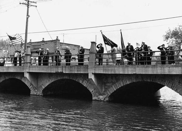 "American Legion Post 270 members assemble on the bridge on Memorial Day."