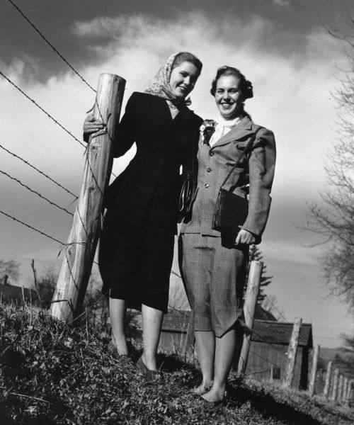 "Eunice Lamers & Mary Ann Dreymiller. Henry Heinecke farm buildings are in the background."