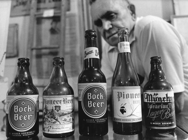 "Les Beck displays beer bottles at the Theresa Historical Society."