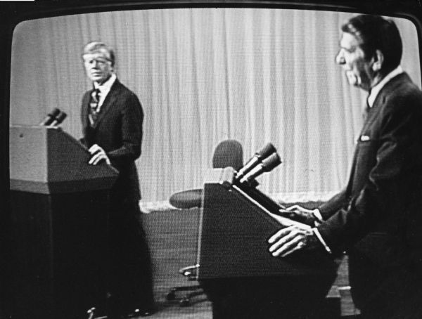 "Jimmy Carter and Ronald Reagan engage in a presidential debate on television."
