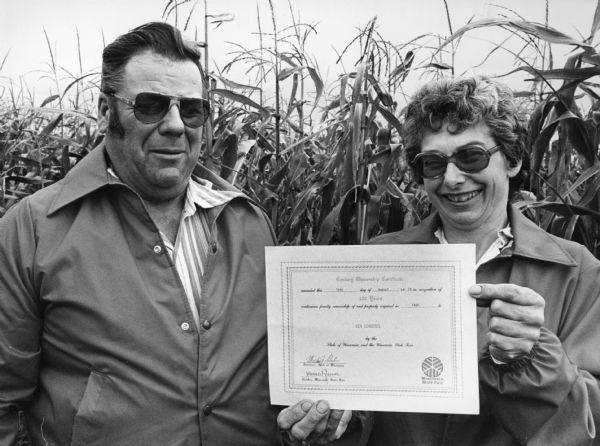 "Ken & LaVerne Schoebel proudly display a Century Ownership Certificate.  The Schoebel family purchased the land in 1869."