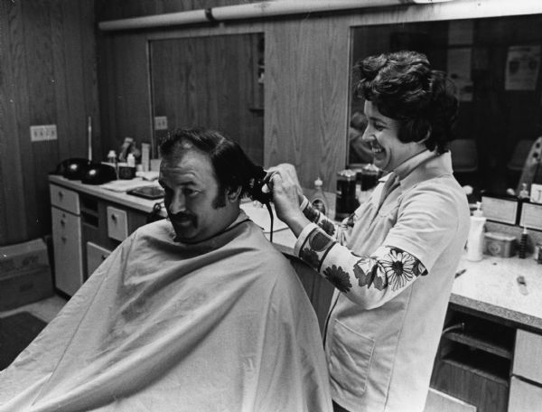 "Jan Reuter cuts Philip Zingsheim's hair. Jan's husband, Carl, died an untimely death in 1975."