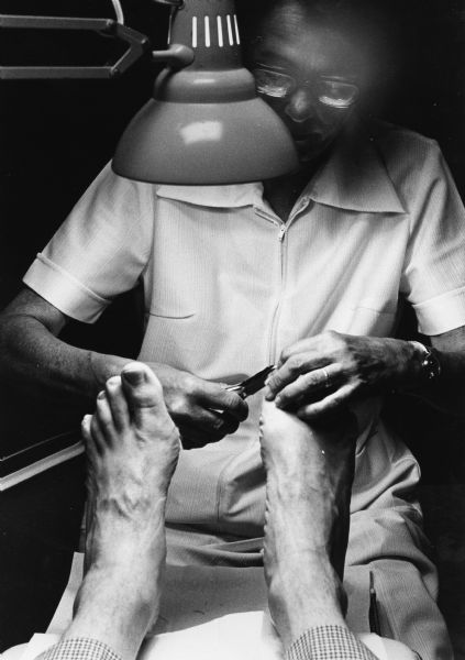 "Podiatrist Dr. Helen Walters of Fond du Lac does her thing on a patient's feet."