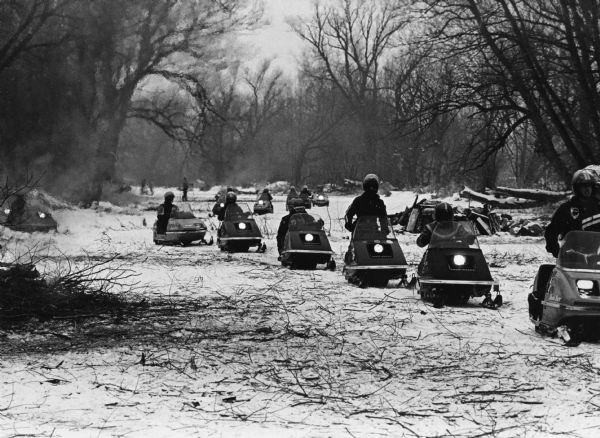 "Snowmobiles make their way along the Rock River."