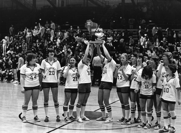 "Lomira High School girl's basketball team celebrates winning the state championship."