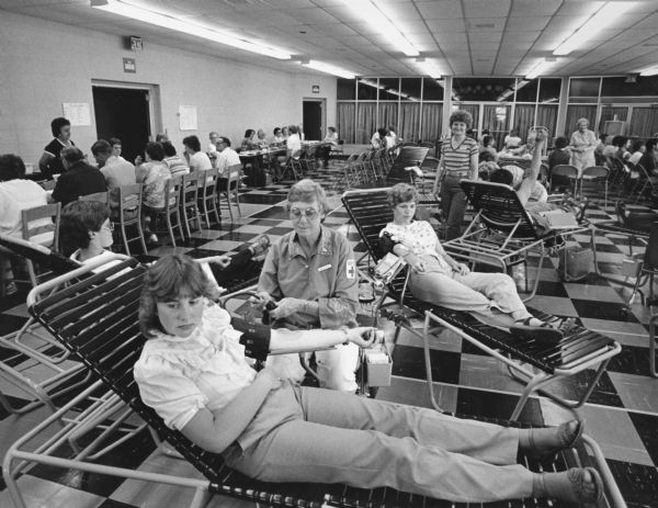 "Trinity United Methodist parish hall, Lomira, was the setting for the Red Cross Blood Drive. Tami Schwartz, 19, is in the foreground."