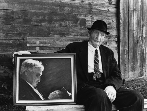 "Ed Radke, 96, posed with a painting by Betty Zedler, talented Lomira artist. The painting is a faithful reproduction of a black & white photo taken earlier as he worshipped at St. Peter's Lutheran Church."