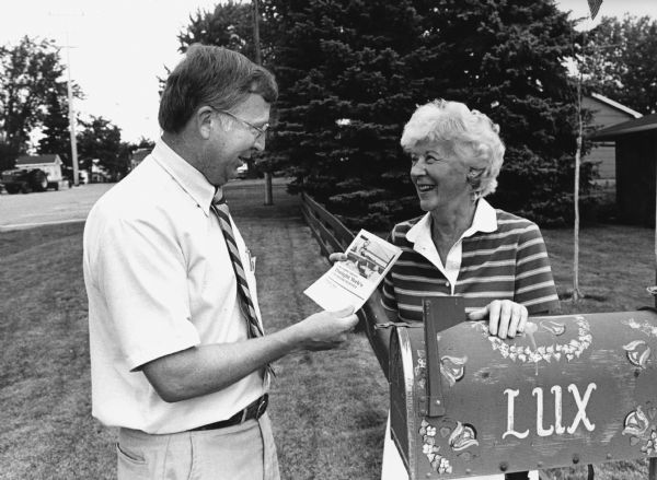"Dwight York, Republican candidate for the 59th Assembly District, hands out campaign literature to Lucille Lux."