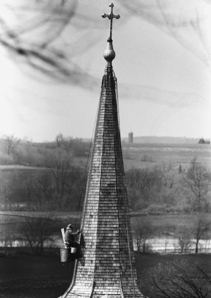 "Workers do steeple repair on St. Peter's Church."