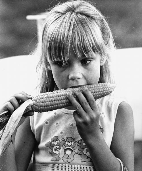 "Jeanette Walsh, daughter of Mr. & Mrs. Tom Walsh, enjoyed some corn at the Theresa Lions Annual Corn Roast."