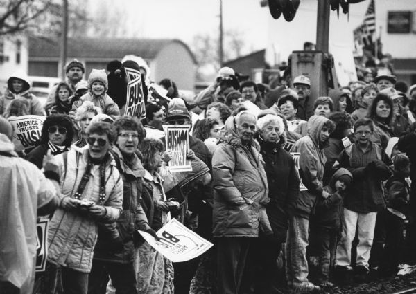 "Hundreds of onlookers crowded around the Wisconsin Central Railroad tracks in downtown Lomira eagerly waiting for the George Bush 'Spirit of America' campaign train."