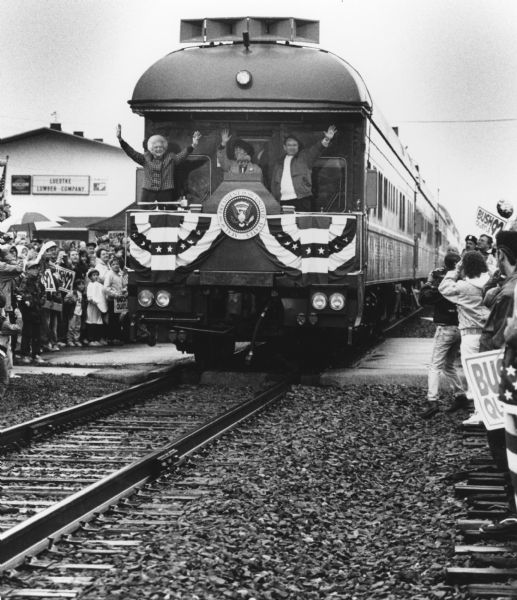 "As the Bush campaign train rolled through Lomira around 12:45, onlookers hoping to catch a glimpse of President Bush had to settle for waves from Barbara Bush and Governor and Mrs. Tommy Thompson."