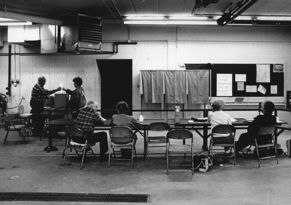 "Poll workers wait for voters in the November election. For president results were: George Bush 169 votes, Bill Clinton 133 votes, Ross Perot 127 votes, and other 2 votes."