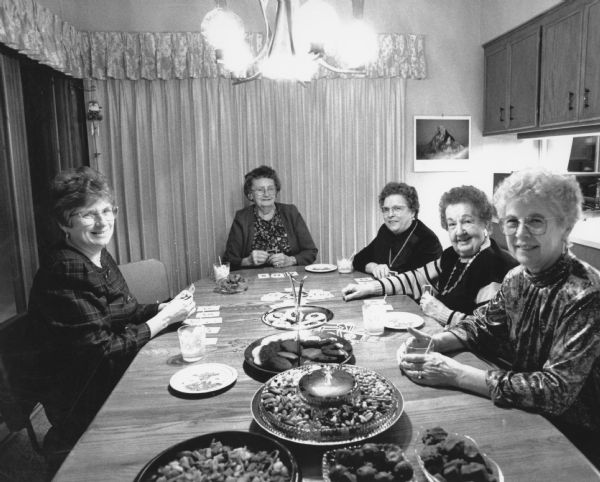 "Pioneer Homemakers Christmas Party. L-R: Betty Schmidt, Myrtle Luhn, Loretta Sauer, Rogeen Franzen, and Shirley Widmer."