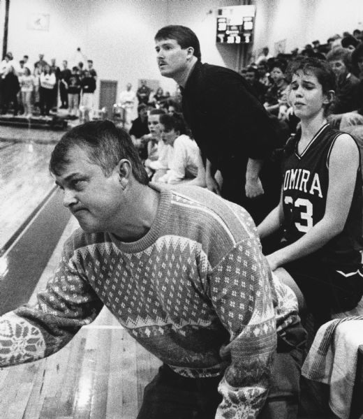 "It was an intense moment in the Lomira-Markesan game when the camera caught coaches Ric Bloohm, foreground, and Tim Wilke urging on their team. Becky Zahn is #33."