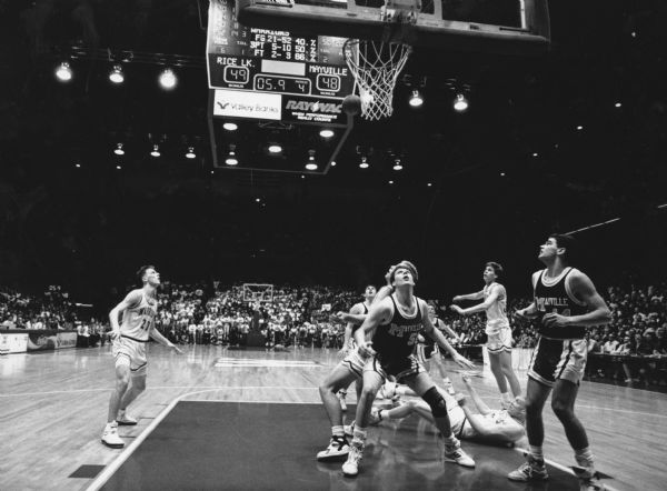 "In WIAA basketball at the field house in Madison, with 5.9 seconds remaining in the game and the Mayville Cards down by one point, this basket missed its mark. Rice Lake went on to win the game 51-48."