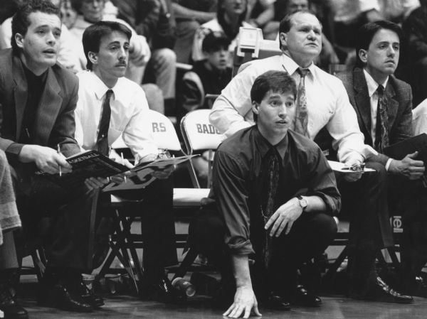 "Mayville head coach, Jon Nedelcoff (hand on floor), and assistant coaches agonized through the final moments of the game."