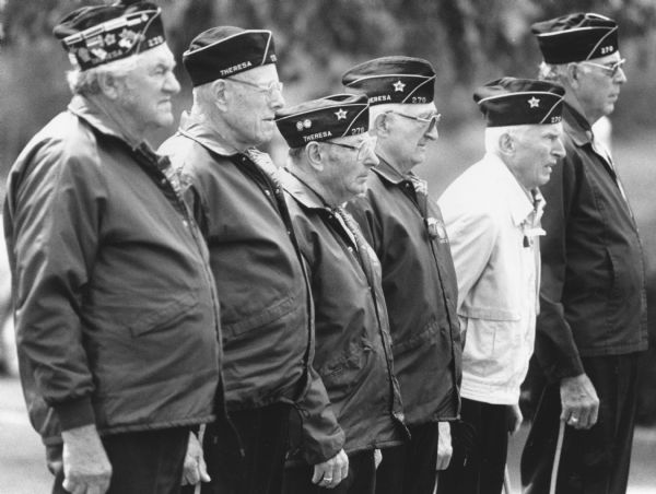 "Legionnaires Hubert Oechsner, Pete Bodden, Rudy Heinecke, Rueben Beck, Ralph Widmer, and Paul Koll stand at attention on Memorial Day."