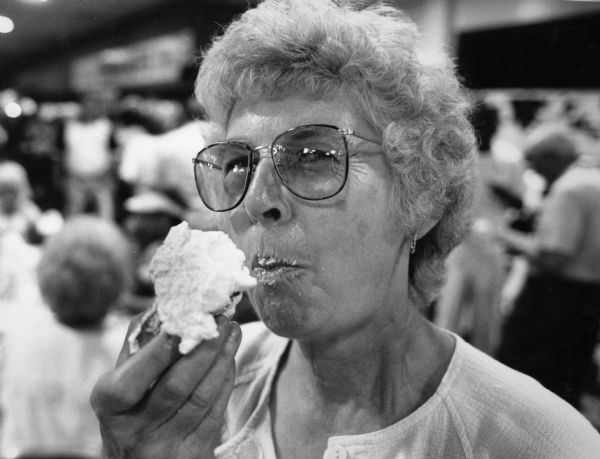 "One of the staples at the Wisconsin State Fair is cream puffs. Shirley Widmer is enjoying one."