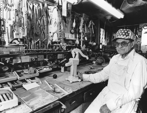 "Ossie Reimer, Lomira handyman, is pictured in his well-stocked workshop. He spends up to 60 hours, 7 days a week, in his shop."
