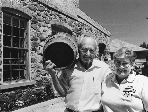 "'Gebby' Weber, with daughter Karen, hoisted an empty beer keg on his shoulder to recreate the Journal photo on the opposite page [Page 48]."