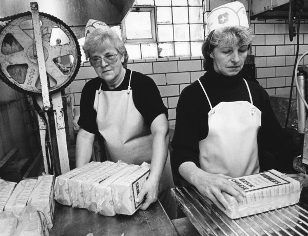 Janet Wendling and Marilyn Zingsheim package brick cheese at Widmer Cheese.