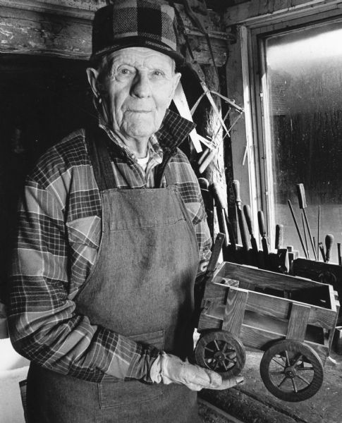 "John Reklau, age 92, was photographed while busily working in his tidy workshop room that once housed his chickens."