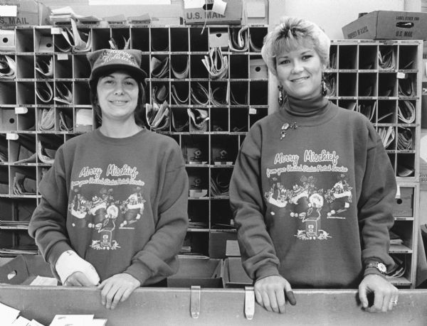 "Postal employees, Sheri Trautman & Mari Marks, are decked out for the Christmas Season."