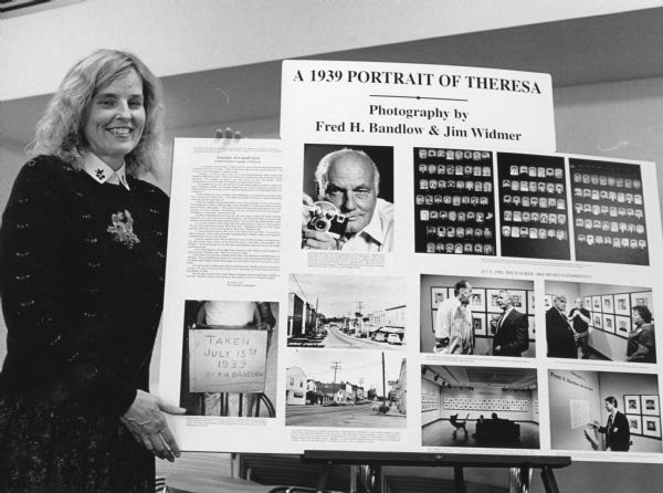 "Cheryl Gage, Assistant Director at the Fond du Lac Public Library, poses with a board, touting the photography of Fred H. Bandlow."