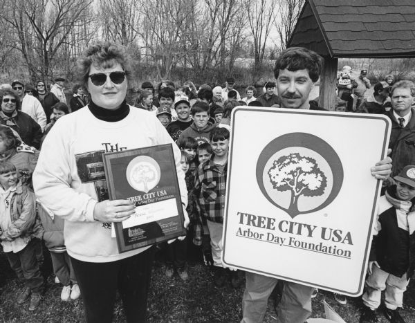 "Village President Chris Giese accepts a Tree City USA Award on Arbor Day."