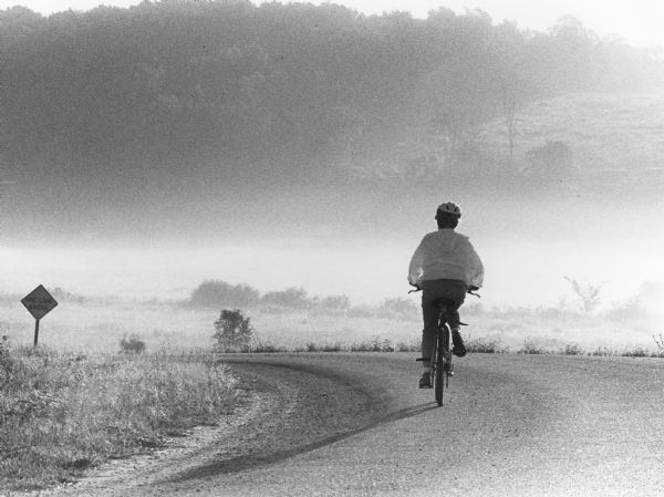 "A lone biker glides off into the distance on a misty McArthur Road."