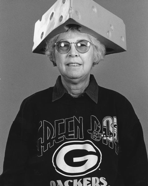 "Shirley Widmer wearing the famous 'Cheese Hat.'"
Shirley Widmer dressed as a Green Bay Packer fan with cheesehead hat and Packer sweatshirt.