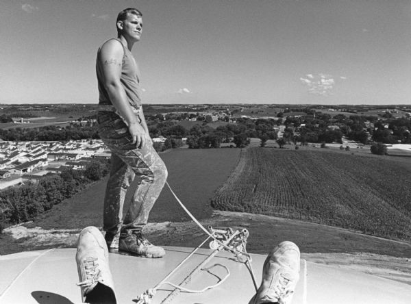 "Painter Casey Montroy of Monmouth, IL is nonchalant on top of the 200,000 gallon tank."
