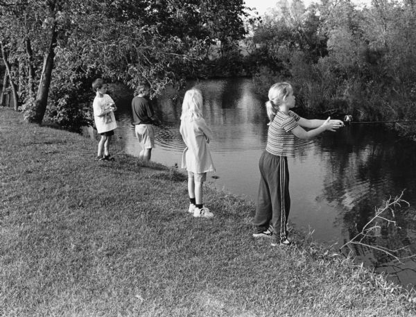"Anglers try their luck on the Rock River (L-R): Logan Wilz, Joe Wilz, Carly Hren, and Chelsey Wilz."
