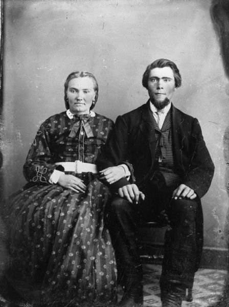 Portrait of couple sitting together with their arms linked. Unidentified tintype copy by Alexander Krueger.