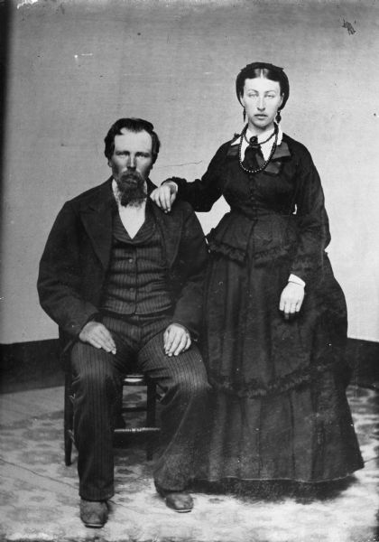 Full-length wedding portrait of Mr. and Mrs. August Krueger.