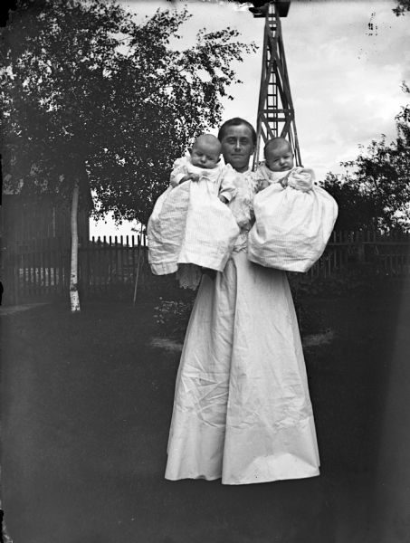 Outdoor portrait of Florentina Krueger holding twin babies Edgar and Jennie Krueger.