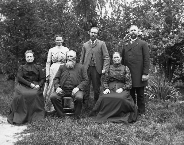 Portrait of six Krueger brothers and sisters. Sitting are Amelia, August, and Bertha. Standing are Minnie, Albert, and Henry.