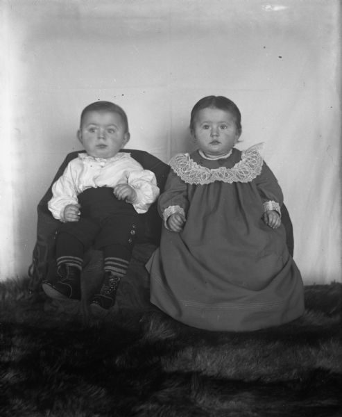 Portrait of Edgar and Jennie Krueger at the age of 11 months, 17 days.  Edgar, wearing his father's baby clothes, wears the waist that his father wore when he was two years old in 1874.