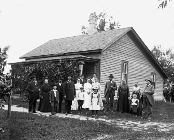 Members of the Krause and Krueger family standing in front of the William Krause homestead on Boomer Street.