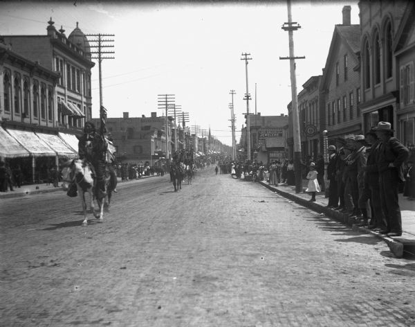 View down Main Street, facing east, during Pawnee Bill's Circus Wild West Parade.