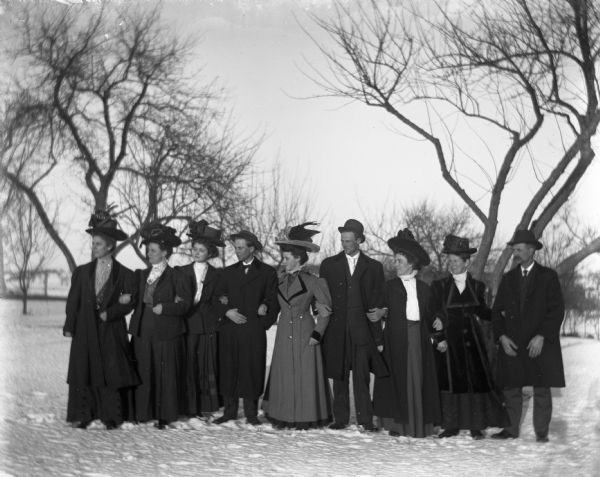 Members of the Krause, Krueger, and Goetsch families stand together in the snow with arms linked.