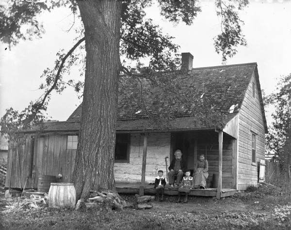Jennie and Edgar Krueger sitting with their great grandparents, William and Johanna Krueger, on their porch across from the family farm.
