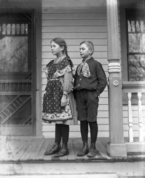Edgar and Jennie Krueger standing together on the front porch of the Krueger home.