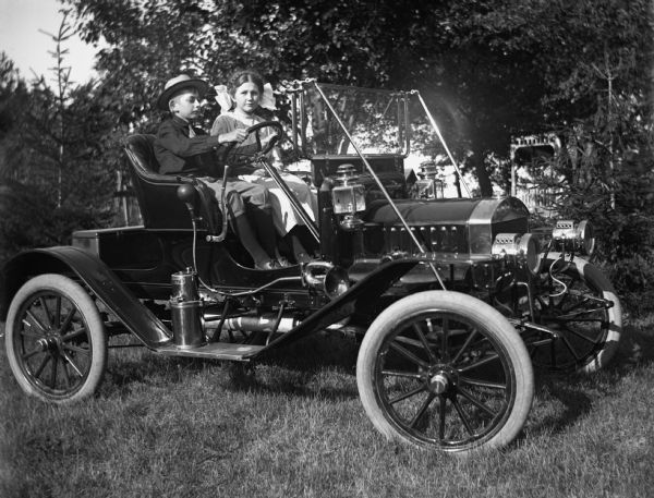 Jennie and Edgar Krueger posing in Theodore Mueller's Maxwell car.