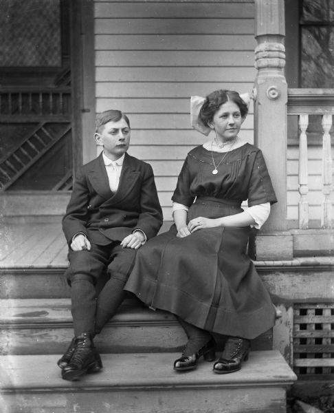 Outdoor portrait of Jennie and Edgar Krueger sitting on the front porch steps of the Krueger home.