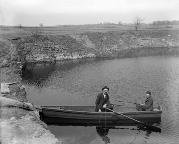 Alexander Krueger and Ernie Buelke fishing in a rowboat on the quarry pond.